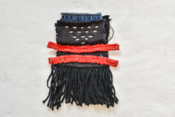 Patchwork of indigo and denim sewn together with white, visible running stitches