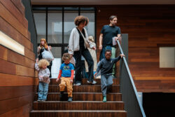 Kids walking down the staircase of the museum with adults