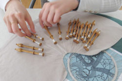 hands making lace