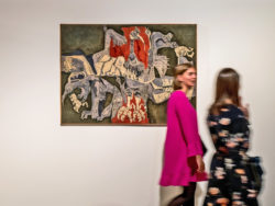 Twee bezoekers lopen langs een kunstwerk in de tentoonstelling "Soft? Tactiele Dialogen".