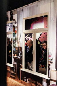 A group of visitors admires the installation of Marina Yee’s studio through the viewing window