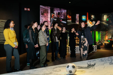 Bezoekers staan rond een voetbal in het Modemuseum van Antwerpen en bekijken de tentoonstelling over de Antwerp Six van Dirk Bikkembergs.