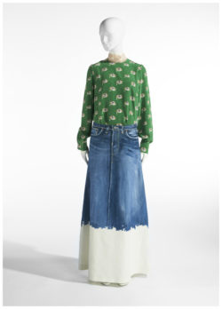 Model in green top, with print, and long jean skirt with white bottom