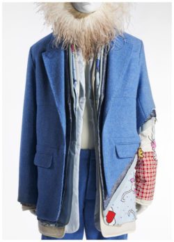 Mannequin in blue layered vest and pantaloons, with feather headdress around head