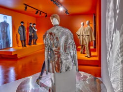 Image of the exhibition in MoMu. In the foreground a mannequin in a silver silhouette by Maison Martin Margiela.