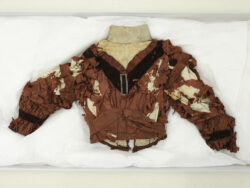 Bodice made from dark brown silk fabric, featuring a V-shaped neckline trimmed with a pleated strip in the same material.