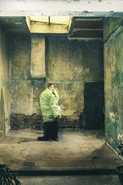 A model poses in an abandoned artist's studio wearing clothes designed by Floran Polano