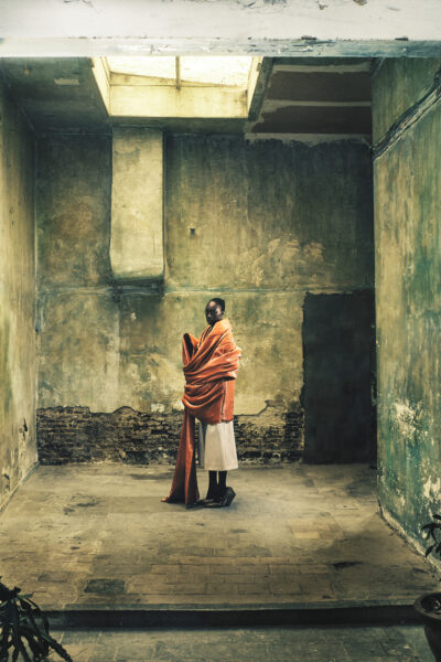A model poses in an abandoned artist's studio wearing clothes designed by Floran Polano