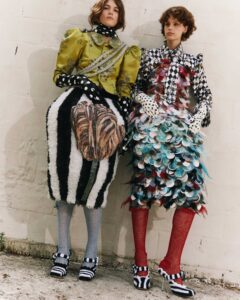 Two models pose in front of a wall in clothing designed by Annaëlle Reudink