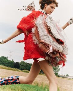 A model running through a field wearing Annaëlle Reudink&#039;s clothing designs
